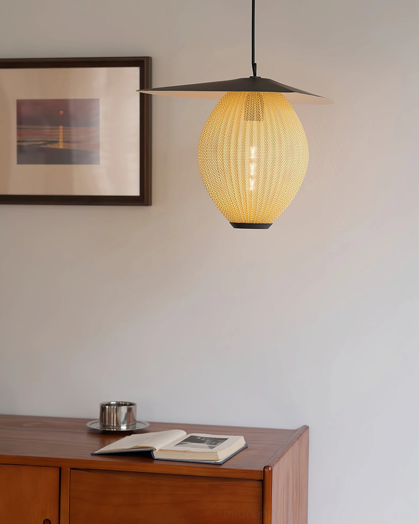 Yellow Satellite pendant light with exposed LED bulb and black metal top in hallway