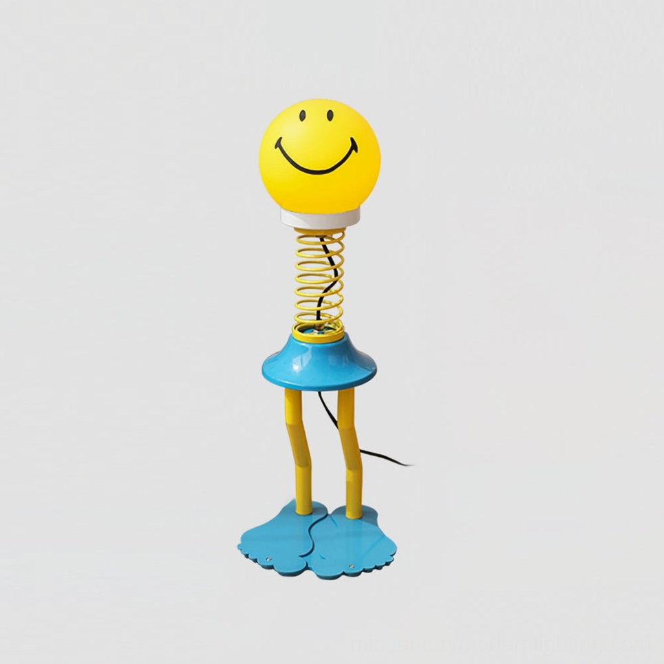 Yellow smiley face spring table lamp full product display with spiral metal base and barefoot feet design