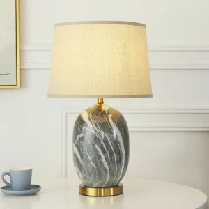 Yopal table lamp on side table with coffee set, showing warm ambient light and linen shade detail