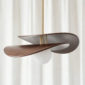 Close-up detail of Zane pendant light showing dark walnut wood grain, brass stem, and frosted opal glass diffuser