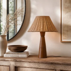 Zaya rattan lamp positioned on wooden sideboard with vintage home decor and pottery, bohemian interior styling