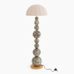 Zebra floor lamp with bold black and white striped wooden sphere base and cream pleated fabric shade, front studio view