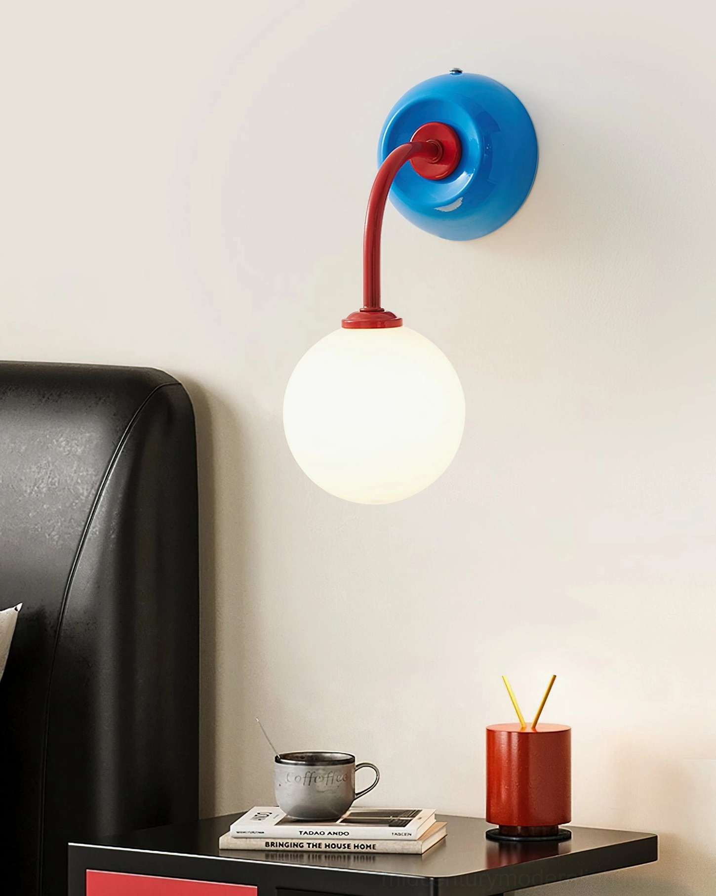 Blue-based Zesta modern wall sconce at eye level in bedroom bedside space, minimalist design demonstrating functional bedroom lighting solution